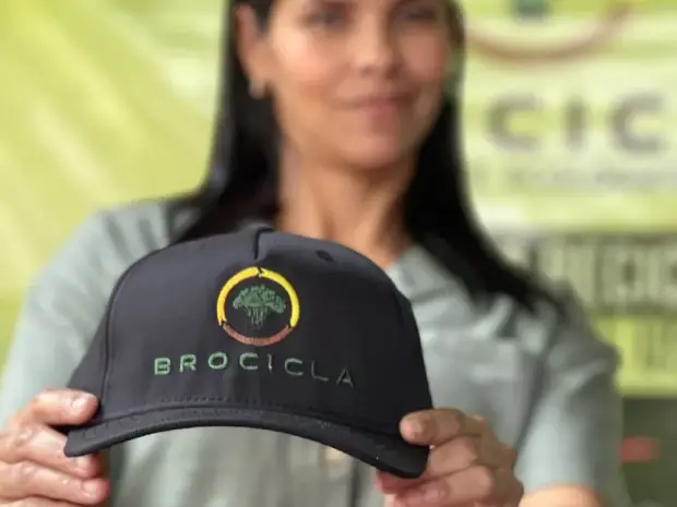 Integrante del equipo mostrando la gorra de Brocicla en una jornada